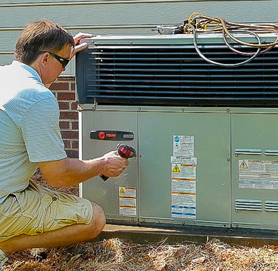 Man working on outside AC unit